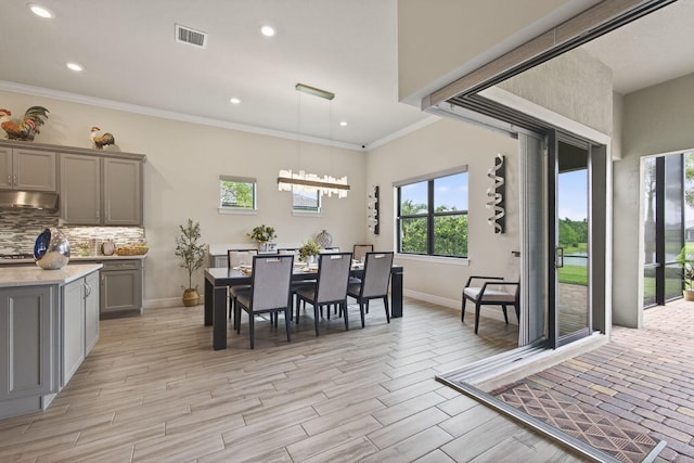 11620 Sally Ann Dr, Palm Beach Gardens, FL 33412 - dining space with baseboards, recessed lighting, crown molding, and light wood finished floors