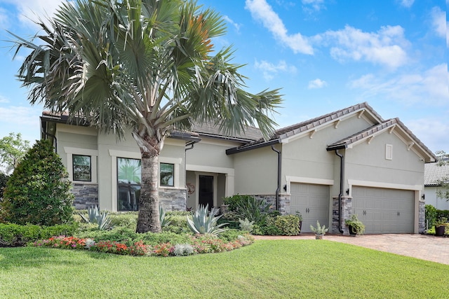 11620 Sally Ann Dr, Palm Beach Gardens, FL 33412 - view of front of property featuring stone siding, an attached garage, and a front lawn