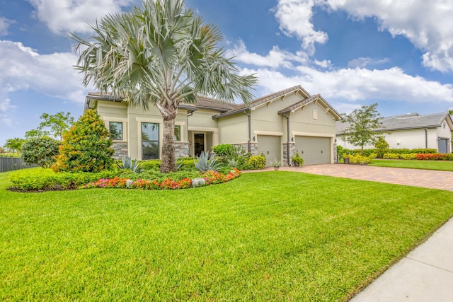 11620 Sally Ann Dr, Palm Beach Gardens, FL 33412 - view of front facade featuring decorative driveway, stucco siding, stone siding, and an attached garage