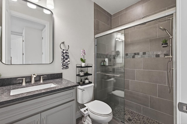 11620 Sally Ann Dr, Palm Beach Gardens, FL 33412 - bathroom with toilet, vanity, and a stall shower