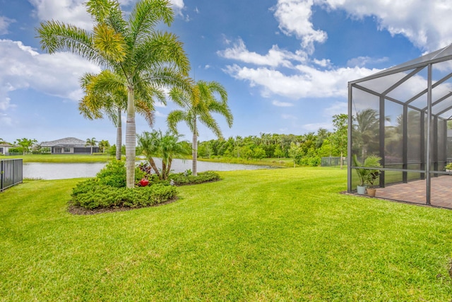 11620 Sally Ann Dr, Palm Beach Gardens, FL 33412 - view of green lawn featuring a water view, glass enclosure, and a patio
