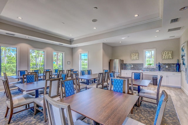 11620 Sally Ann Dr, Palm Beach Gardens, FL 33412 - dining area featuring a tray ceiling, ornamental molding, recessed lighting, and light wood finished floors