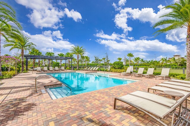 11620 Sally Ann Dr, Palm Beach Gardens, FL 33412 - community pool featuring a patio area and a pergola