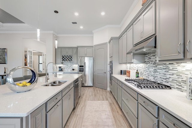 11620 Sally Ann Dr, Palm Beach Gardens, FL 33412 - kitchen featuring gray cabinetry, stainless steel appliances, a sink, crown molding, and under cabinet range hood