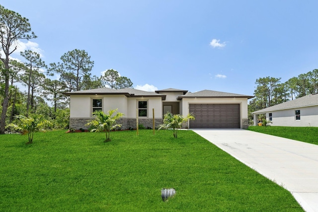 518 Scodella St SW, Palm Bay, FL 32908 - prairie-style home featuring stucco siding, stone siding, a garage, driveway, and a front yard