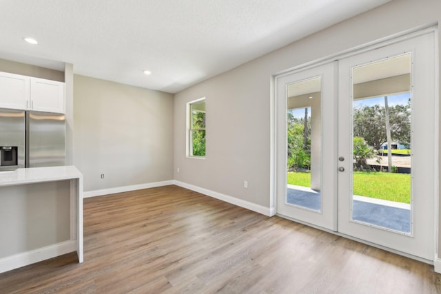 518 Scodella St SW, Palm Bay, FL 32908 - unfurnished living room featuring french doors, light wood-type flooring, baseboards, and recessed lighting