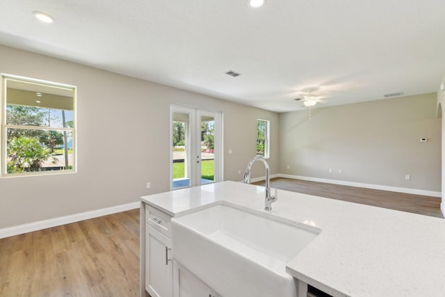 518 Scodella St SW, Palm Bay, FL 32908 - kitchen with a sink, light wood-type flooring, baseboards, and recessed lighting