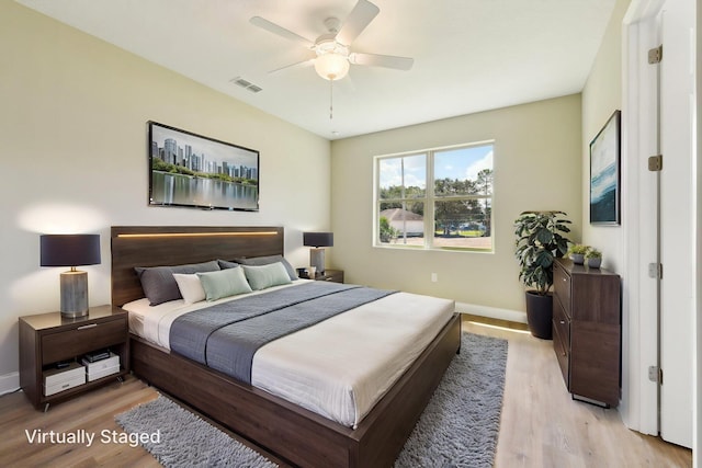 518 Scodella St SW, Palm Bay, FL 32908 - bedroom with light wood-style flooring, baseboards, and a ceiling fan