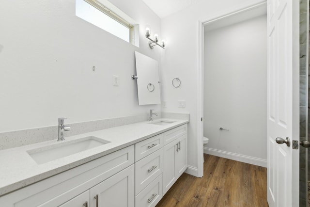 518 Scodella St SW, Palm Bay, FL 32908 - full bathroom with double vanity, toilet, wood finished floors, and baseboards