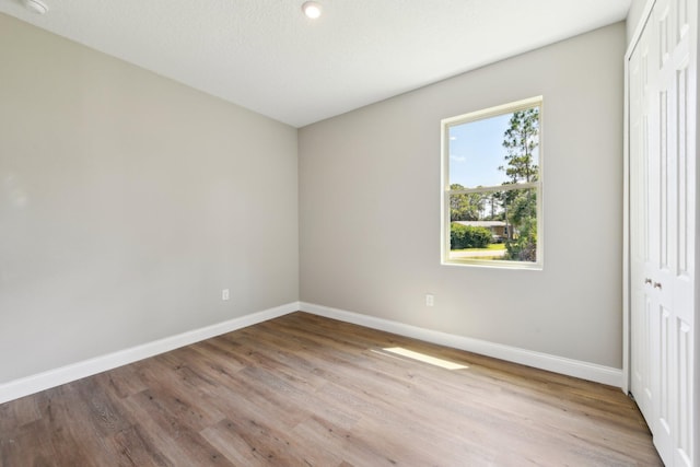 518 Scodella St SW, Palm Bay, FL 32908 - unfurnished bedroom with a closet, baseboards, and wood finished floors