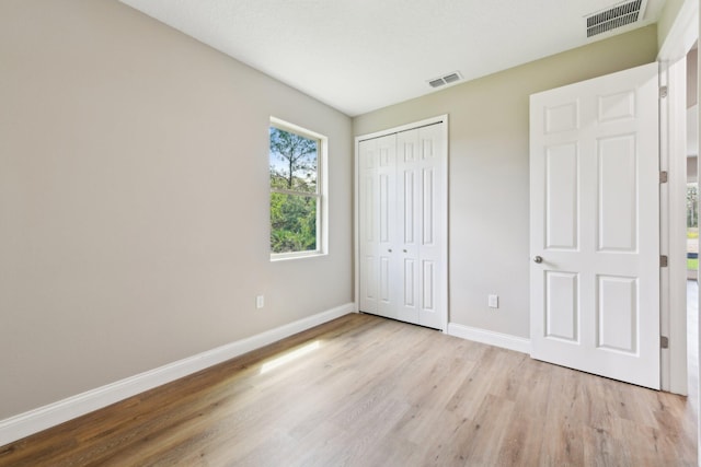 518 Scodella St SW, Palm Bay, FL 32908 - unfurnished bedroom featuring baseboards, wood finished floors, and a closet