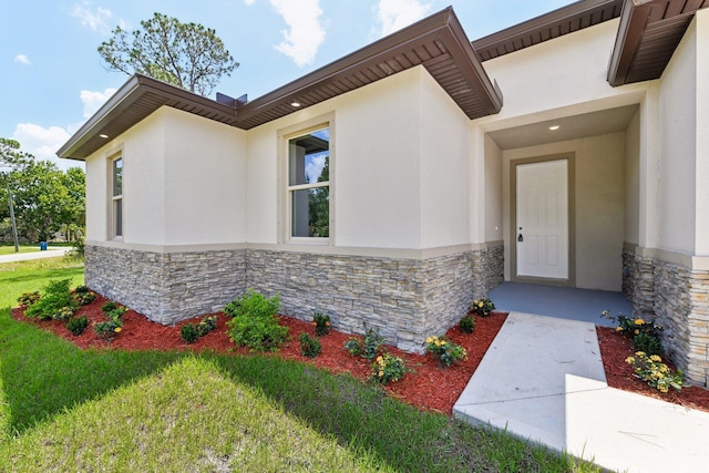 518 Scodella St SW, Palm Bay, FL 32908 - entrance to property featuring stone siding, stucco siding, and a yard