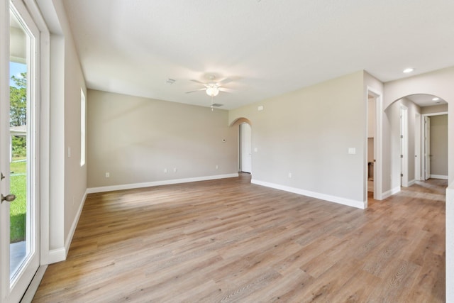 518 Scodella St SW, Palm Bay, FL 32908 - unfurnished room with arched walkways, ceiling fan, light wood-style floors, baseboards, and recessed lighting