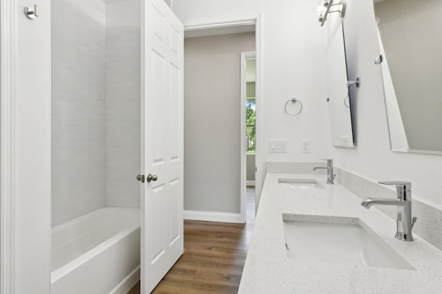 518 Scodella St SW, Palm Bay, FL 32908 - full bath featuring double vanity, wood finished floors, baseboards, and bathing tub / shower combination