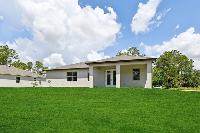 518 Scodella St SW, Palm Bay, FL 32908 - rear view of property featuring french doors, stucco siding, and a lawn