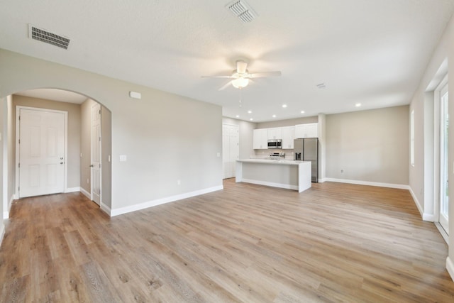 518 Scodella St SW, Palm Bay, FL 32908 - unfurnished living room with arched walkways, ceiling fan, light wood-type flooring, baseboards, and recessed lighting
