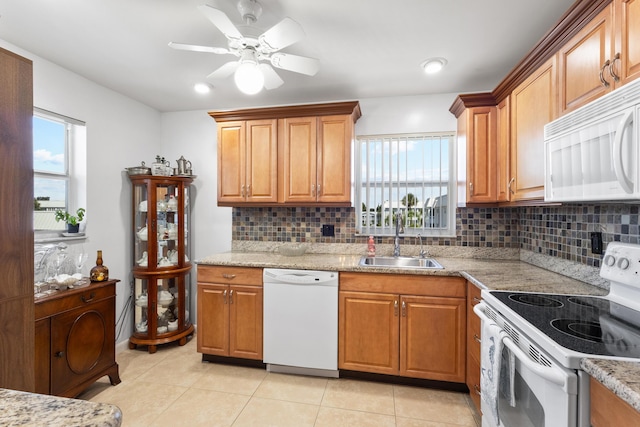 7 Colonial Club Dr Unit 300, Boynton Beach, FL 33435 - kitchen with white appliances, a sink, light tile patterned floors, and backsplash
