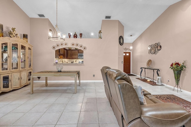 5830 Parkwalk Cir W, Boynton Beach, FL 33472 - living room with vaulted ceiling, light tile patterned floors, a chandelier, and baseboards