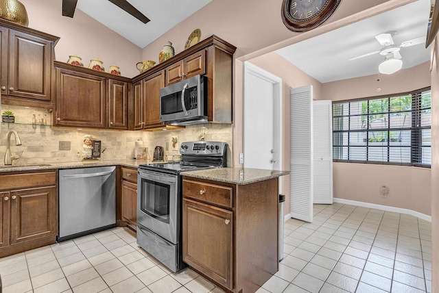 5830 Parkwalk Cir W, Boynton Beach, FL 33472 - kitchen featuring appliances with stainless steel finishes, a ceiling fan, a sink, light tile patterned flooring, and vaulted ceiling