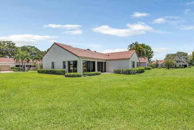 5830 Parkwalk Cir W, Boynton Beach, FL 33472 - back of house with stucco siding, a tile roof, and a yard