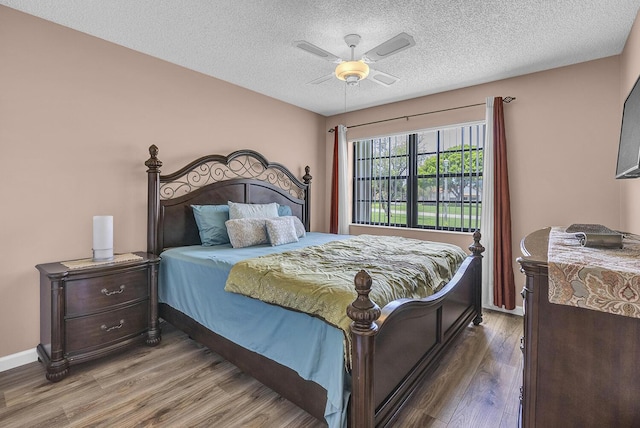 5830 Parkwalk Cir W, Boynton Beach, FL 33472 - bedroom with wood finished floors, ceiling fan, a textured ceiling, and baseboards