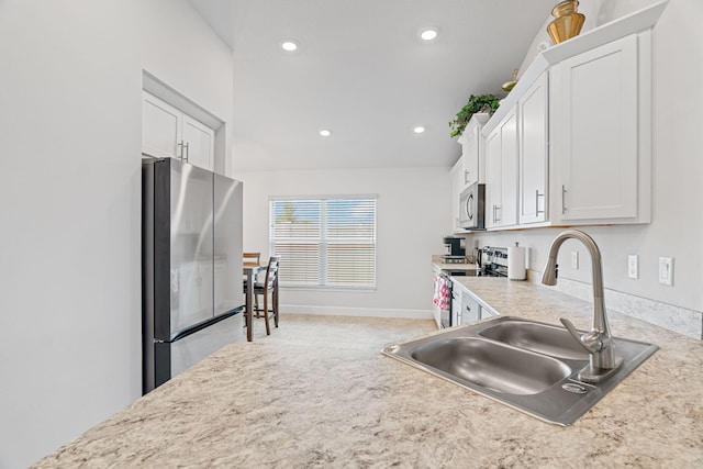 5309 Vespera St, Fort Pierce, FL 34951 - kitchen with stainless steel appliances, a sink, white cabinetry, light countertops, and recessed lighting