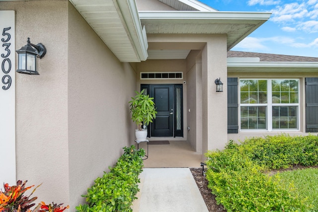 5309 Vespera St, Fort Pierce, FL 34951 - entrance to property featuring stucco siding and a shingled roof