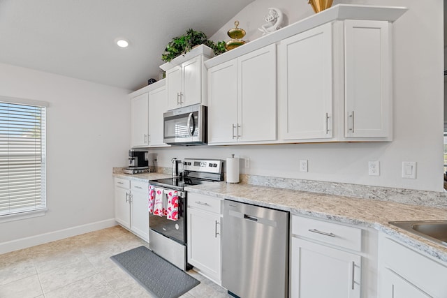5309 Vespera St, Fort Pierce, FL 34951 - kitchen with stainless steel appliances, white cabinetry, light countertops, baseboards, and recessed lighting