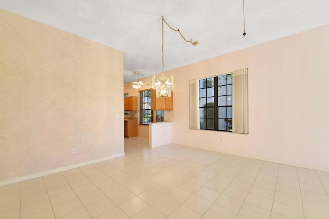 4560 Sherwood Forest Dr, Delray Beach, FL 33445 - unfurnished room with a chandelier and light tile patterned flooring