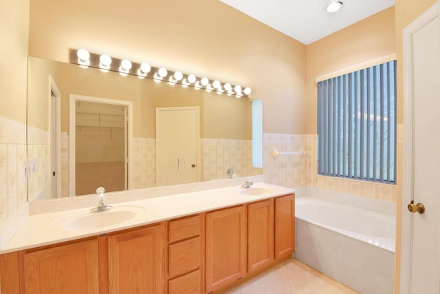 4560 Sherwood Forest Dr, Delray Beach, FL 33445 - bathroom with a garden tub, double vanity, tile patterned flooring, and a walk in closet