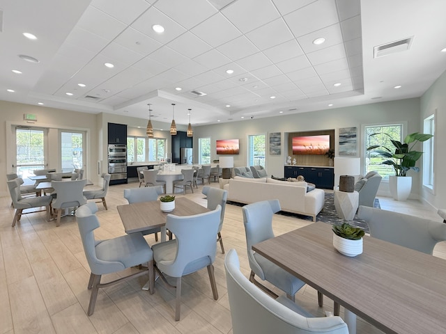 4560 Sherwood Forest Dr, Delray Beach, FL 33445 - dining room with a tray ceiling, a drop ceiling, light wood-style floors, and recessed lighting