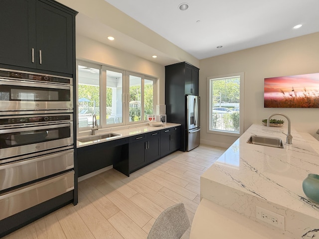 4560 Sherwood Forest Dr, Delray Beach, FL 33445 - kitchen with a sink, dark cabinets, appliances with stainless steel finishes, and recessed lighting