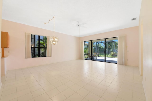 4560 Sherwood Forest Dr, Delray Beach, FL 33445 - spare room with ceiling fan, a chandelier, and light tile patterned floors