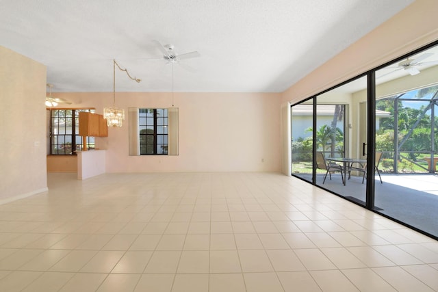4560 Sherwood Forest Dr, Delray Beach, FL 33445 - spare room with ceiling fan, a chandelier, and light tile patterned floors
