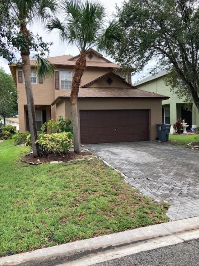 1098 Winding Rose Way, West Palm Beach, FL 33415 - traditional home featuring stucco siding, decorative driveway, a garage, a front yard, and a chimney