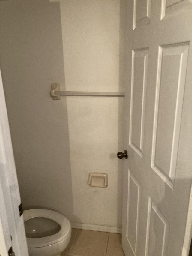 1098 Winding Rose Way, West Palm Beach, FL 33415 - bathroom with toilet, tile patterned floors, and baseboards