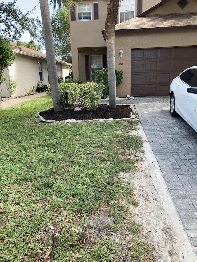 1098 Winding Rose Way, West Palm Beach, FL 33415 - view of front of home featuring a garage, stucco siding, driveway, and a front yard