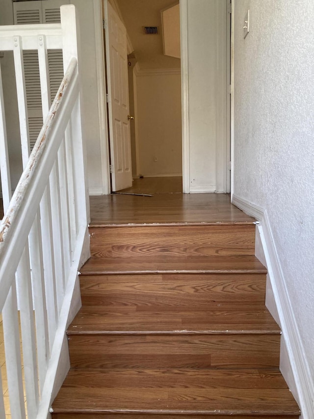 1098 Winding Rose Way, West Palm Beach, FL 33415 - stairway featuring a textured wall and wood finished floors