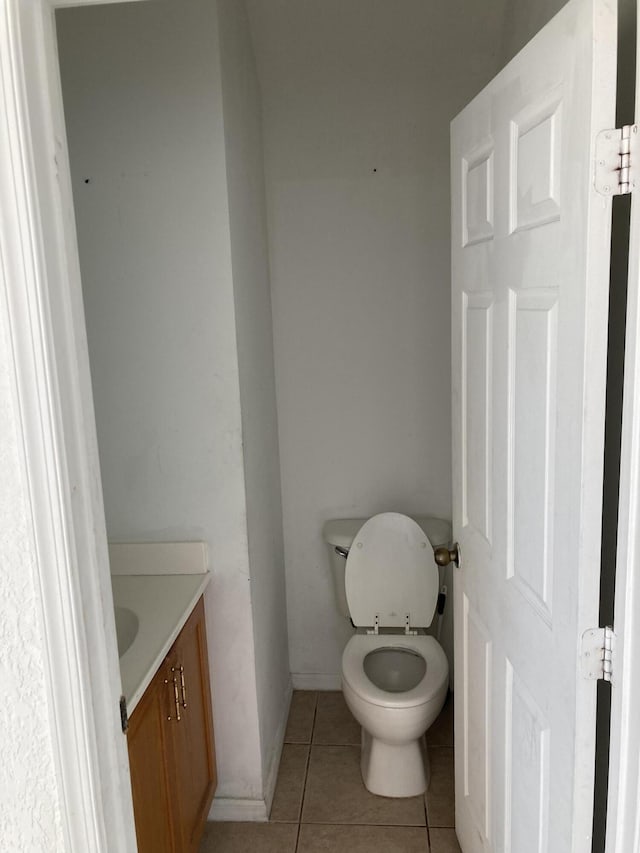 1098 Winding Rose Way, West Palm Beach, FL 33415 - bathroom with vanity, tile patterned flooring, toilet, and baseboards