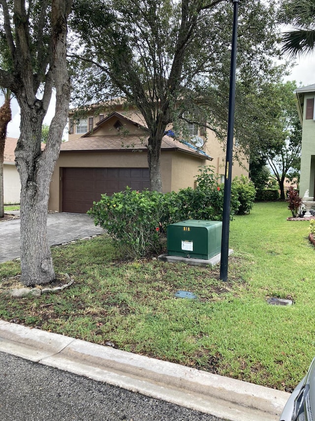 1098 Winding Rose Way, West Palm Beach, FL 33415 - view of front of property featuring a front lawn, an attached garage, driveway, and stucco siding