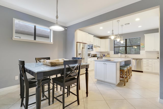 568 SE Monet Dr, Port Saint Lucie, FL 34984 - dining space featuring ornamental molding, plenty of natural light, light tile patterned floors, and recessed lighting