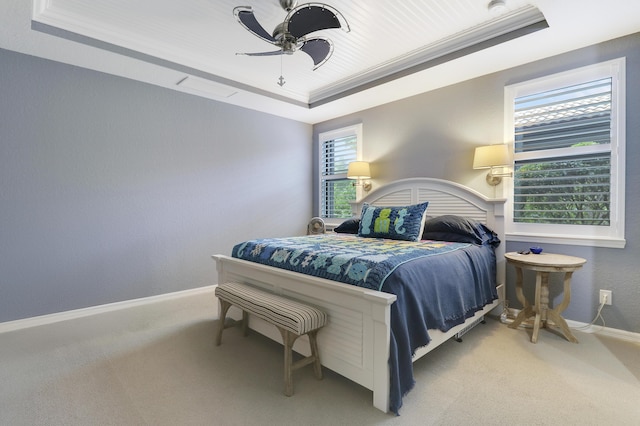 568 SE Monet Dr, Port Saint Lucie, FL 34984 - carpeted bedroom with a tray ceiling, baseboards, and a ceiling fan