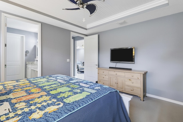 568 SE Monet Dr, Port Saint Lucie, FL 34984 - bedroom with a raised ceiling, ornamental molding, ensuite bathroom, a ceiling fan, and baseboards