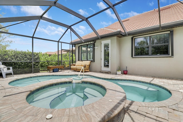568 SE Monet Dr, Port Saint Lucie, FL 34984 - view of pool featuring a pool with connected hot tub, a patio area, and a lanai
