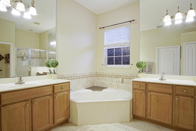 697 SW Dairy Rd, Port Saint Lucie, FL 34953 - full bath featuring a shower stall, two vanities, a bath, and tile patterned floors