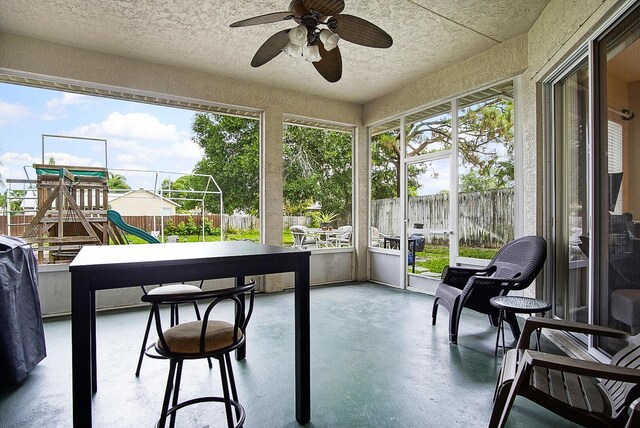 697 SW Dairy Rd, Port Saint Lucie, FL 34953 - sunroom with finished concrete floors, a ceiling fan, and a textured ceiling
