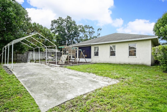 697 SW Dairy Rd, Port Saint Lucie, FL 34953 - rear view of property featuring a playground and stucco siding