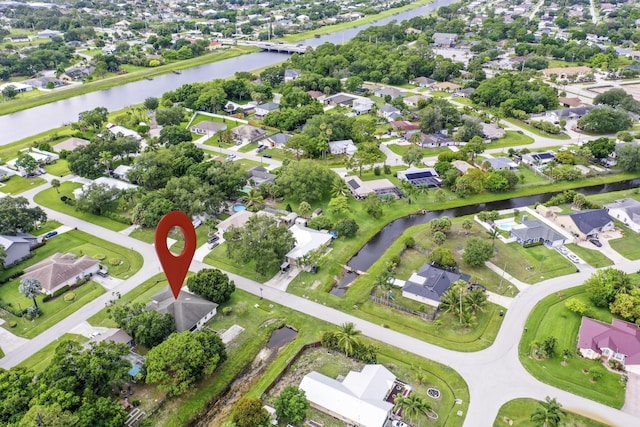 697 SW Dairy Rd, Port Saint Lucie, FL 34953 - aerial overview of property's location with a large body of water and nearby suburban area
