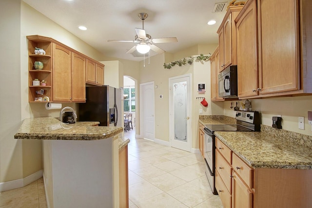 697 SW Dairy Rd, Port Saint Lucie, FL 34953 - kitchen featuring stainless steel appliances, open shelves, baseboards, a ceiling fan, and a peninsula