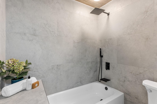 709 SW Bryant Ave, Stuart, FL 34994 - full bathroom with a bathtub, toilet, tile walls, and a shower